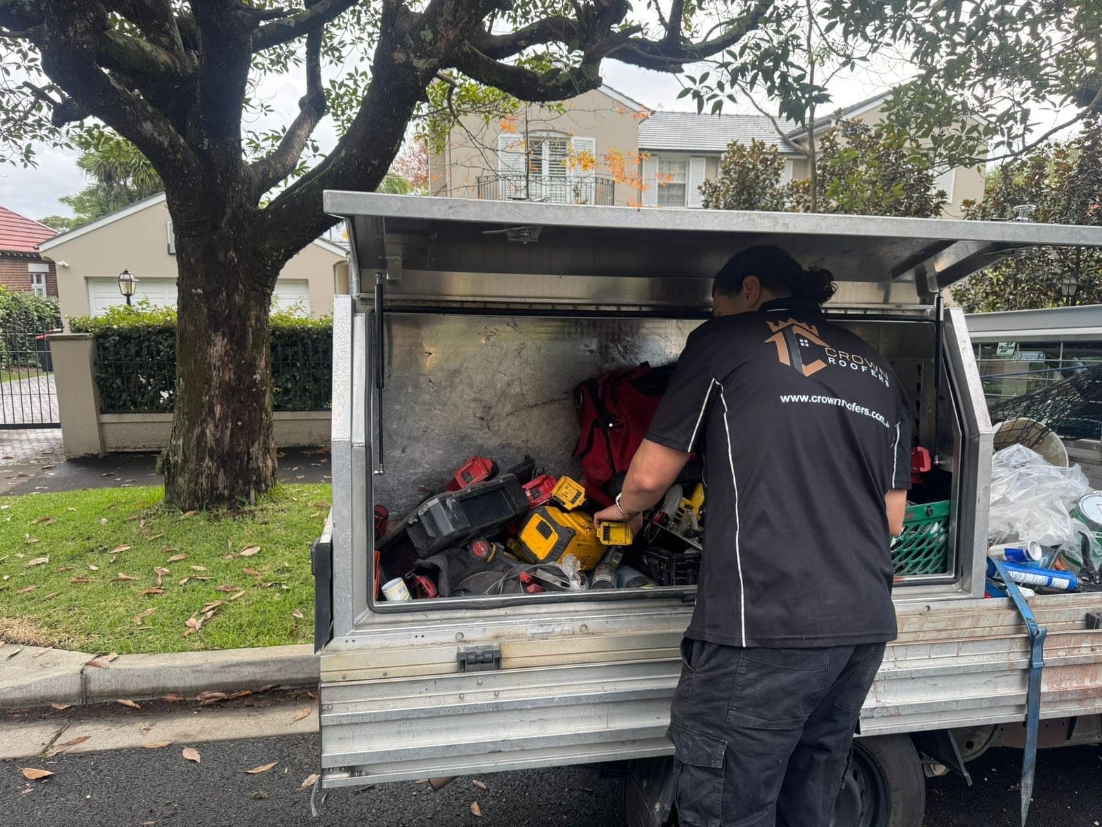 Crown Roofers crew preparing equipment beside their work vehicle